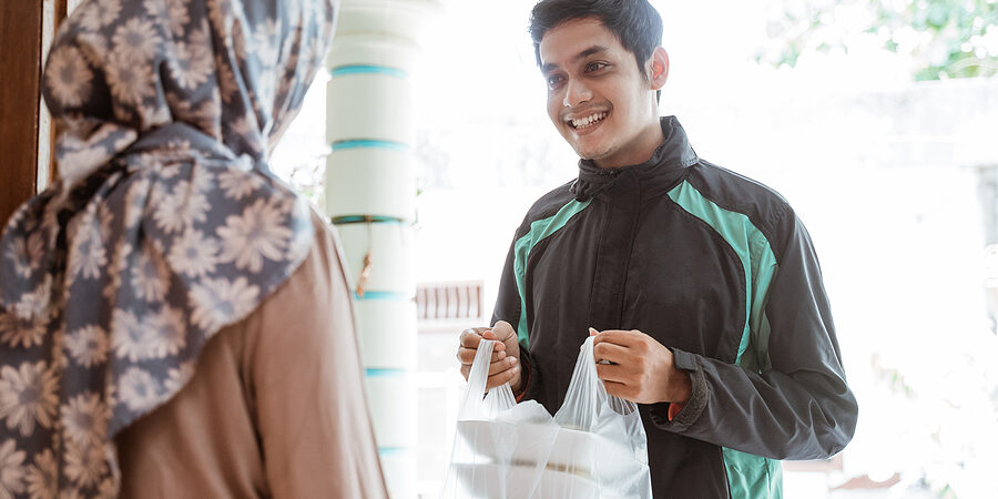 Online Uber Taxi Driver Delivers An Order Of Vegetables